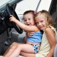 Funny young children are driving big cars